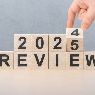 2025 review new year. hand turns wooden cube and changes number Review 2024 to Review 2025. Business, 2025 review new year concept. gray background, copy space.